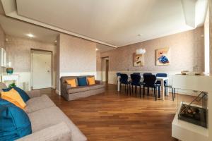 a living room with a couch and a table at Vista su San Pietro - la Venere su Roma Apartment in Rome