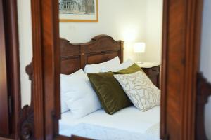 1 cama con almohadas en el espejo en Ca' Alle Gondolette, en Venecia
