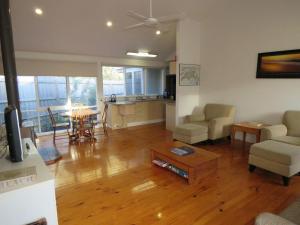 a living room with a couch and a table at 5 Little Penguin Crt, Cowes in Cowes
