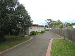 a driveway leading to a house with a fence at 5 Little Penguin Crt, Cowes in Cowes