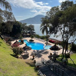 a swimming pool with a view of the water at Hotel Del Dique in Cabra Corral