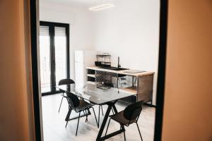 a kitchen with a table and chairs in a room at Greta Apartments in Taranto