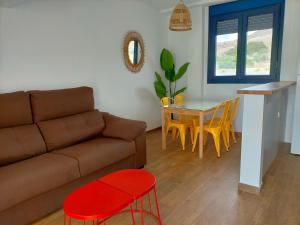 a living room with a couch and a table at Apartamentos Cala San Pedro in Las Negras