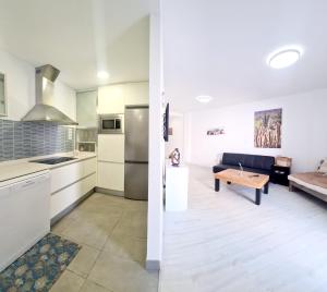 two views of a kitchen and a living room at Vita Ideale in Arguineguín
