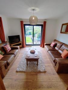 a living room with a couch and a coffee table at Bryn Mynach Annex in Barmouth