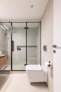 a bathroom with a white toilet and a shower at SKG Urban Boutique in Thessaloniki