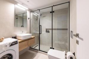 a bathroom with a shower and a toilet and a sink at SKG Urban Boutique in Thessaloniki