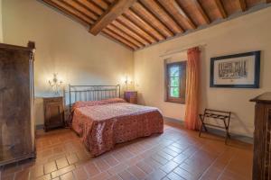 sypialnia z łóżkiem i oknem w obiekcie Fattorie Santo Pietro w mieście San Gimignano
