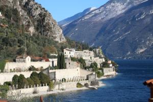a town on the shore of a body of water at La Casa sul Lago Apartments - Olive Tree Apartment in Limone sul Garda