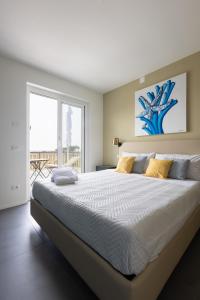 a bedroom with a large bed and a large window at Sweet Sicily Apartments in Carini