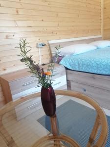 a vase sitting on a chair in a bedroom at Hiška Zeleni raj in Podnart