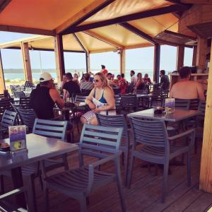 a group of people sitting at tables in a restaurant at Villa M, App 4 - 6 persons direct on the seaside, 1st floor in Ljubač