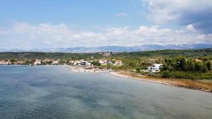 a view of a beach with houses and buildings at Villa M, App 4 - 6 persons direct on the seaside, 1st floor in Ljubač +16 photos