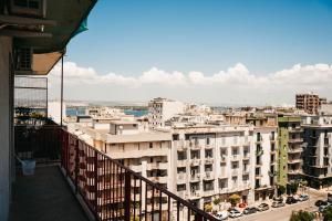 a view of a city from the balcony of a building at Greta Apartments in Taranto