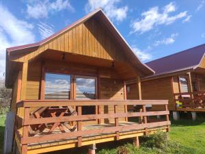a log cabin with a large deck in front of it at Domki letniskowe Kama 514-280-102 in Solina
