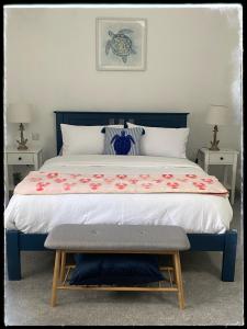 a bedroom with a large bed with a blue headboard at Sanctuary Lodge in Cork