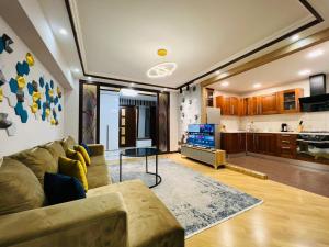 a living room with a couch and a table at City Center Cozy 3Bedroom Apartment with Unique Design and Hot Tub , 2Bathroom, Middle of Center, By Republic Square in Yerevan