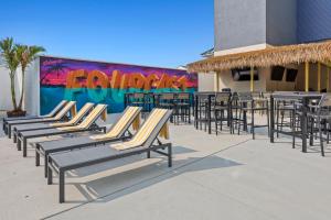 a row of chairs and tables in front of a mural at Seaport Suites in Wildwood