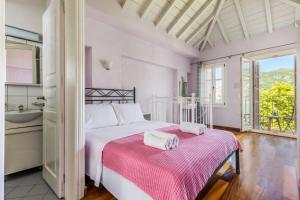 a bedroom with a bed with two towels on it at Sentefi Maisonette in Skopelos Town