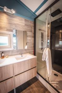 a bathroom with a sink and a shower at Camping le Roucan West in Vias