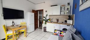 a small kitchen with a table and a dining room at Francisco's Holiday Home in Las Palmas de Gran Canaria