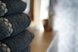 a pile of towels sitting on a wooden floor at Relaxhome in Lindlar
