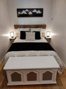 a bedroom with a large bed with two lights at Appartement 65 m² proche pistes in Bolquere Pyrenees 2000