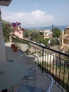 a balcony with a table and chairs and a view at Ipsos Apartment Mari in Kechria