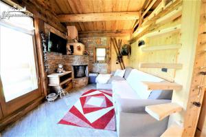 a living room with a couch and a fireplace at Chalet Heaven Mottolino in Livigno