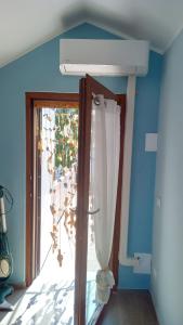 a room with a window and a door with a chandelier at Mansarda a Noli e Spotorno in Noli +16 photos