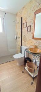 a bathroom with a white toilet and a sink at El Cantón - Alojamiento Rural in Bogarra +54 photos