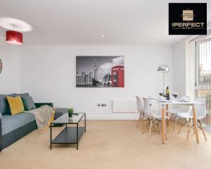 a living room with a couch and a table at Cosmo Modern Apartment Central By Your Perfect Stay Short lets Birmingham in Birmingham