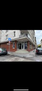 a building on the corner of a street with a blue sign at Viola Hostel in Budapest