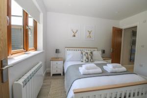 a bedroom with a bed with two pillows on it at Robins Nest in Fareham