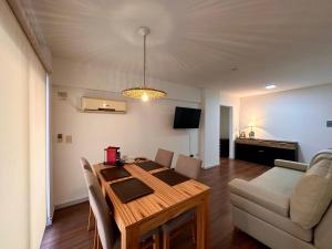 a living room with a wooden table and a couch at Modern&Nordic Apartament Lomitas (2 ambientes) in Lomas de Zamora