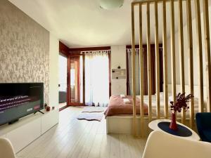 a living room with a television and a bedroom at Marina Panorama Apartment & Garage in Budapest