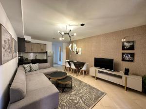 a living room with a couch and a dining room at Apartment Camila in Sarandë