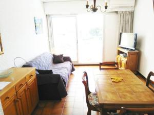 a living room with a couch and a table at STUDIO Climatisé proche plage 4 PERS in Cavalaire-sur-Mer
