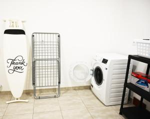 a laundry room with a washer and a washing machine at Luxury Oceanview Villa with Private Pool in Ericeira
