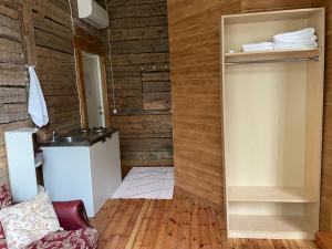 a bathroom with a refrigerator and a sink at Võhma Külamaja, room nr 9 in Võhma