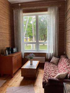 a living room with a couch and a large window at Võhma Külamaja in Võhma