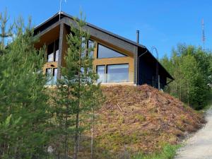 a house on top of a hill with trees at Villa Primus in Ruka