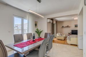 a dining room with a table and chairs at Apartment Renata + PRIVATE swimming pool in SPLIT in Split