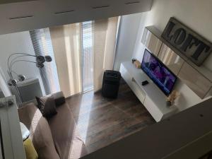 a living room with a flat screen tv on a white cabinet at T2/T3 duplex à Port Frejus proche de la mer in Fréjus