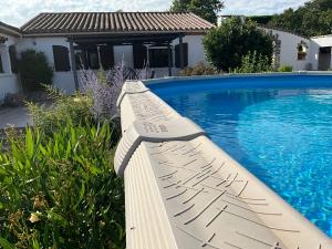 a swimming pool next to a house with a swimming pool at Number9 Studio - Now with air conditioning in Carlipa