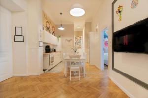 a kitchen with a table and a dining room at Modern Apartments Piłsudskiego Street in Krakow