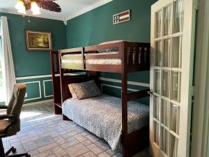 a bedroom with two bunk beds in a room at Entire lake house at Lake Fork with private bay, boat ramp, fishing light & 8 acres land in Alba