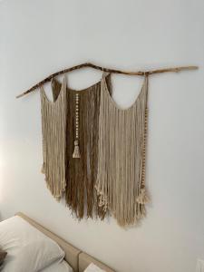a shelf with fringeaments hanging on a wall at Valente Rooms Kythira in Kythira