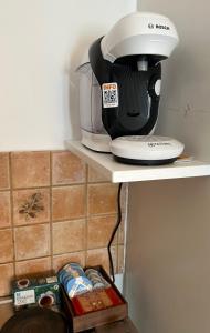 a coffee maker sitting on a shelf in a kitchen at Valente Rooms Kythira in Kythira