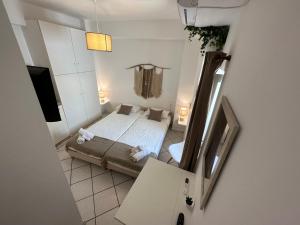 an overhead view of a bedroom with a bed and a television at Valente Rooms Kythira in Kythira